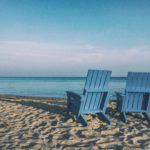 The picture shows to chairs on a beach, representing retirement.