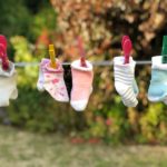 The picture shows baby socks hanging on a family's clothesline.
