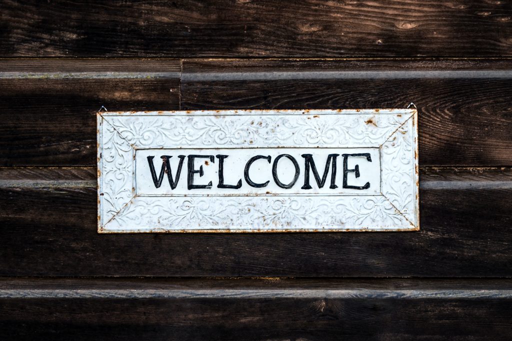 The picture shows a welcome sign to represent welcoming two new employees to the Sensible team.