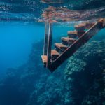 The picture shows stairs going under water to represent bond returns decreasing.