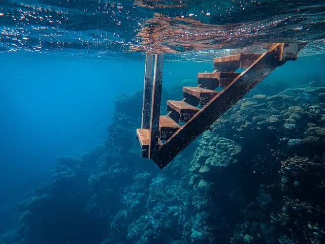 The picture shows stairs going under water to represent bond returns decreasing.