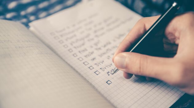 The picture shows a person making a list to represent retirement planning.