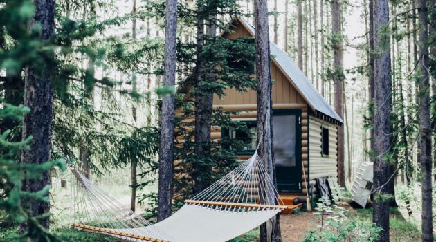 The image is of a cabin in the woods because the article is about buying a retirement vacation home.