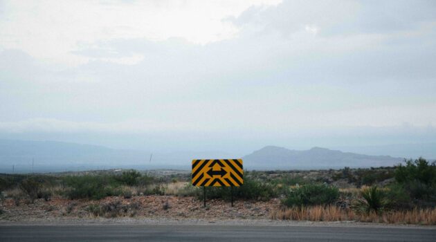 The picture shows an intersection with two choices to represent the career choice the Sanders family must make.