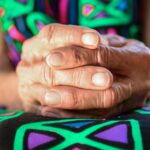 The picture shows an older person's hands to represent the difficult decisions that go into deciding whether to live in a CCRC.