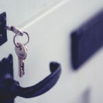 The picture is of a key in the lock of a front door because the article debates buying or renting a house.