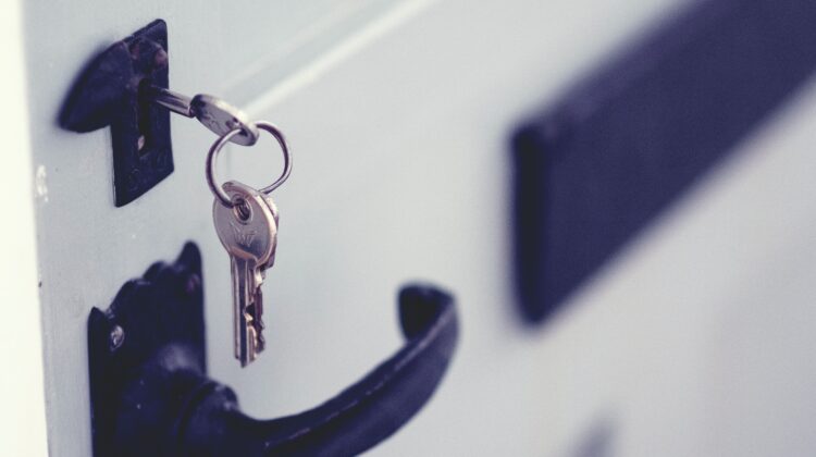 The picture is of a key in the lock of a front door because the article debates buying or renting a house.