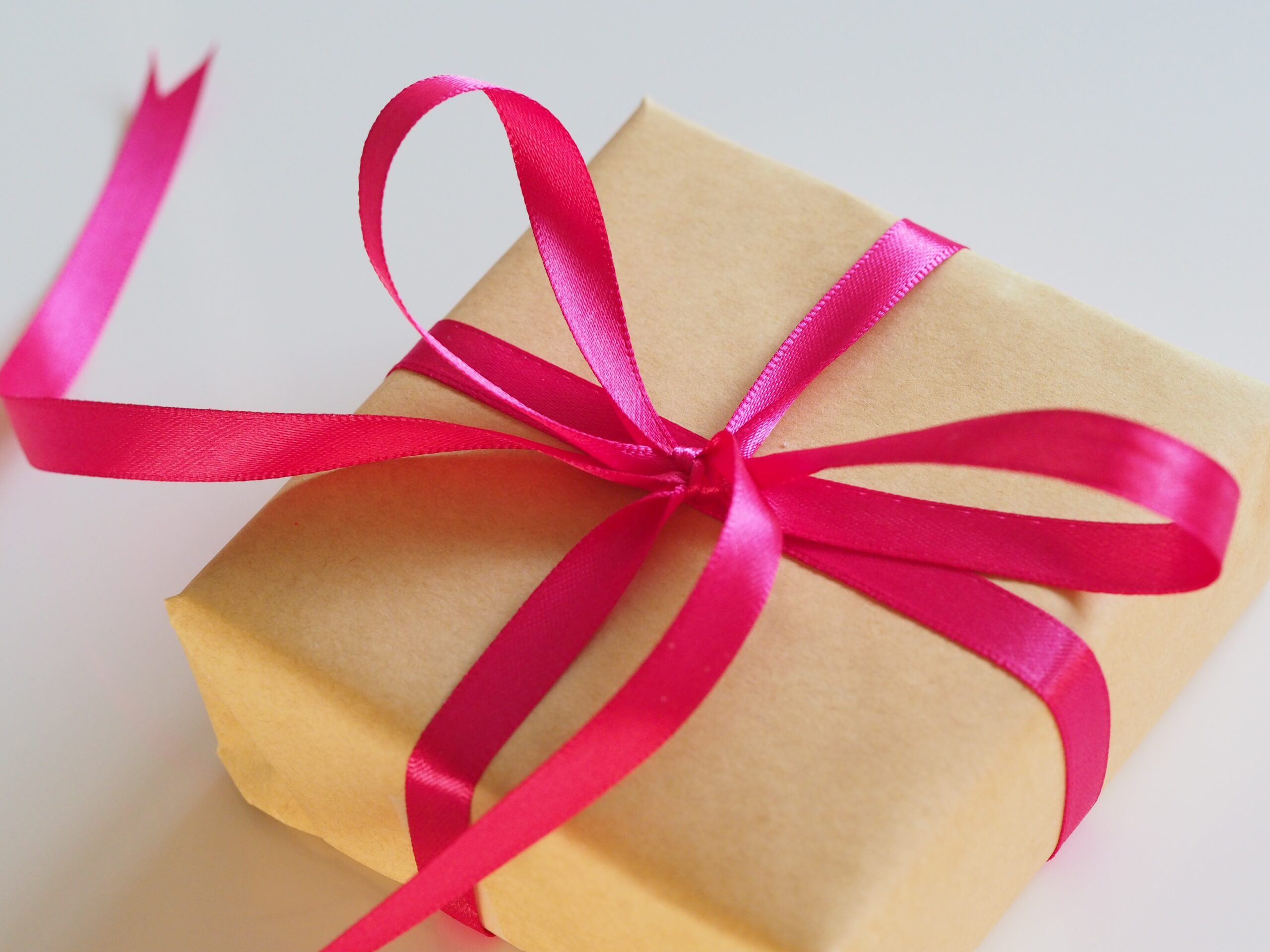 The picture shows a gift wrapped with a ribbon to represent charitable giving.