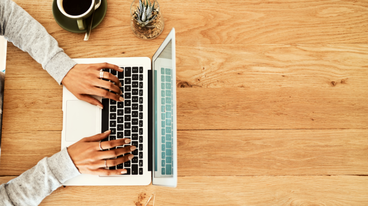 The picture shows a person typing on a keyboard to represent writing articles.