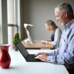 The picture shows a man in his 50s or 60s on a laptop because he is logging into his Social Security account.