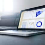 The picture shows a computer screen full of graphs and charts to represent budgeting apps.