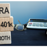 The picture shows blocks next to a calculator. They have IRA, 401k, and Roth written on them because the article is about Roth conversions.